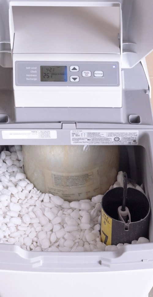water softener with open lid and salt pellets water softener with open lid and salt pellets